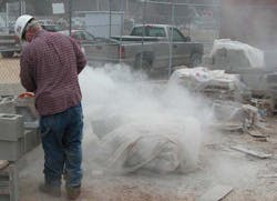 Construction worker cutting concrete block Construction worker cutting concrete block