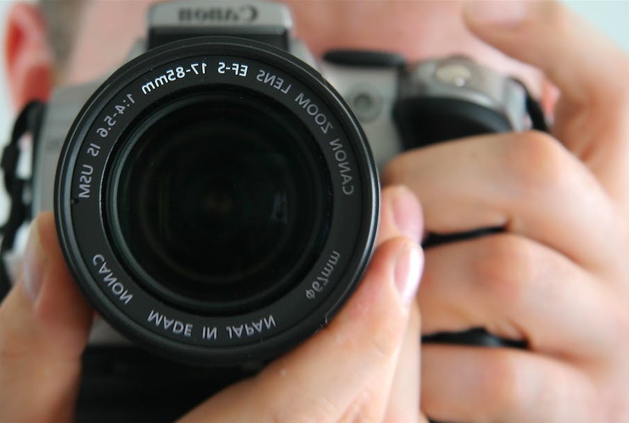 Man using 35 mm SLR camera