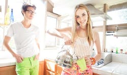 Millennial homeowners looking happy in bright kitchen Millennial homeowners looking happy in bright kitchen