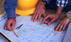 Production manager reviewing plans with client Production manager reviewing plans with client