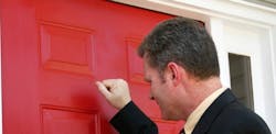 Salesman knocking on door for home improvement sales appointment Salesman knocking on door for home improvement sales appointment