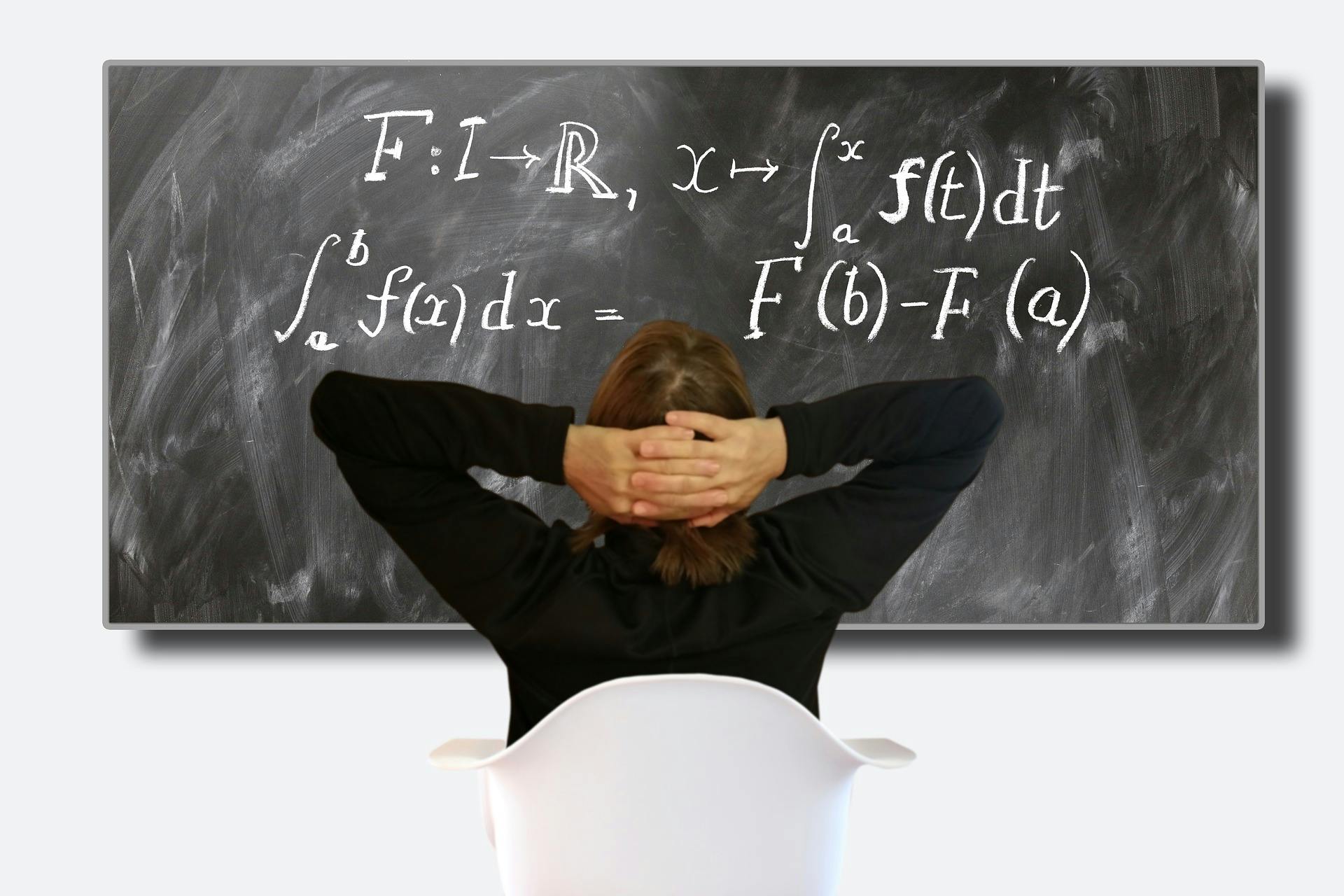 Lessons learned-man ponders equation on blackboard-Pixabay image