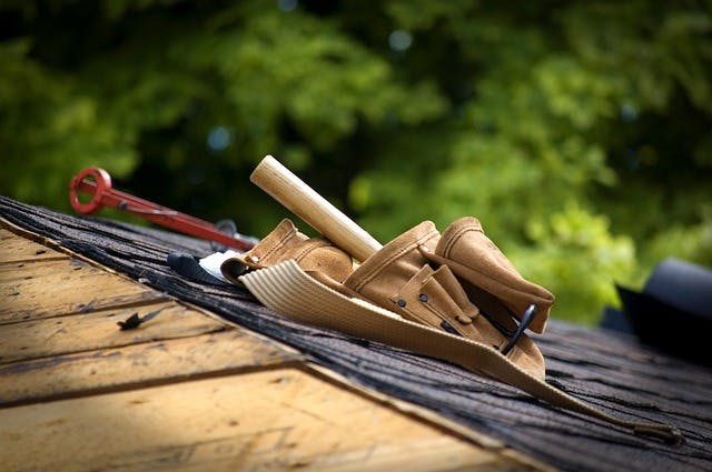 photo of carpenter toolbelt on a roof