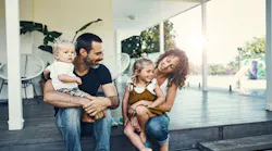 Happy Young Family Spending The Weekend Together At Home