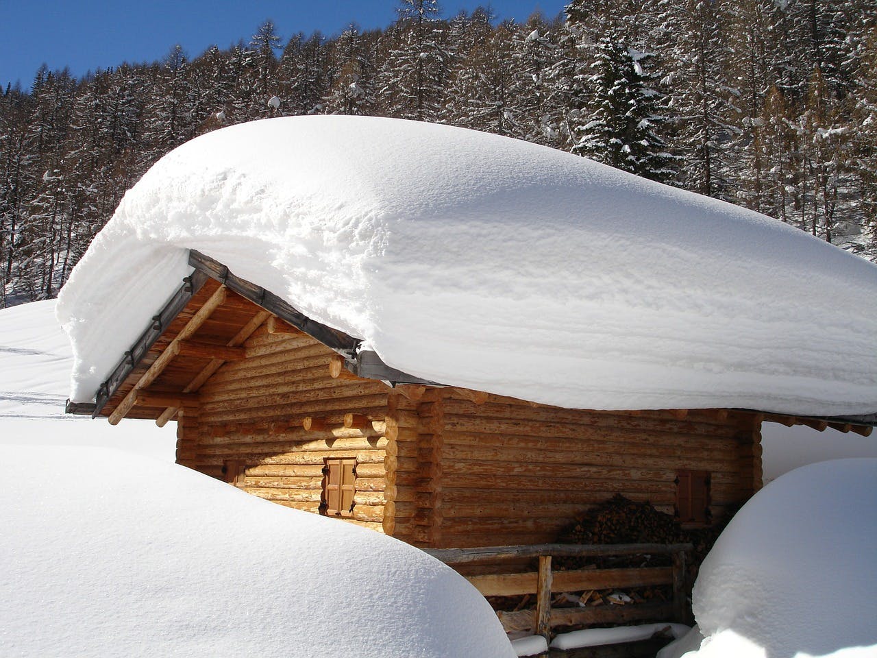 The snow on this roof is several feet deep, but how much snow is too much for a roof and threatens roof collapse?
