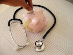 Piggy bank and stethoscope denote health insurance costs rising. Piggy bank and stethoscope denote health insurance costs rising.
