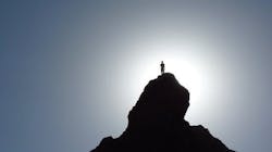 Photo of man atop mountain, without peer, all alone. Photo of man atop mountain, without peer, all alone.