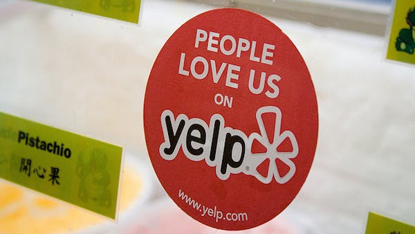 Yelp sticker on business door.
