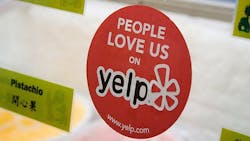 Yelp sticker on business door. Yelp sticker on business door.