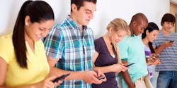 Group of youths communicating via text message Group of youths communicating via text message