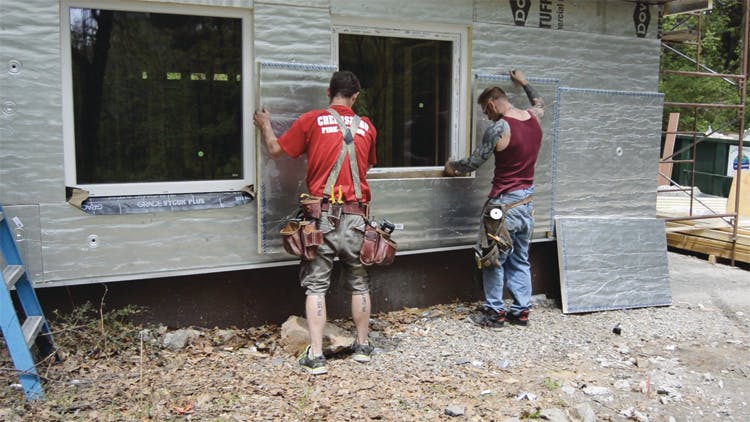 installing rigid foam insulation on home exterior