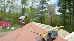 Carpenter ben bogie sheathing the Model ReModel project's roof