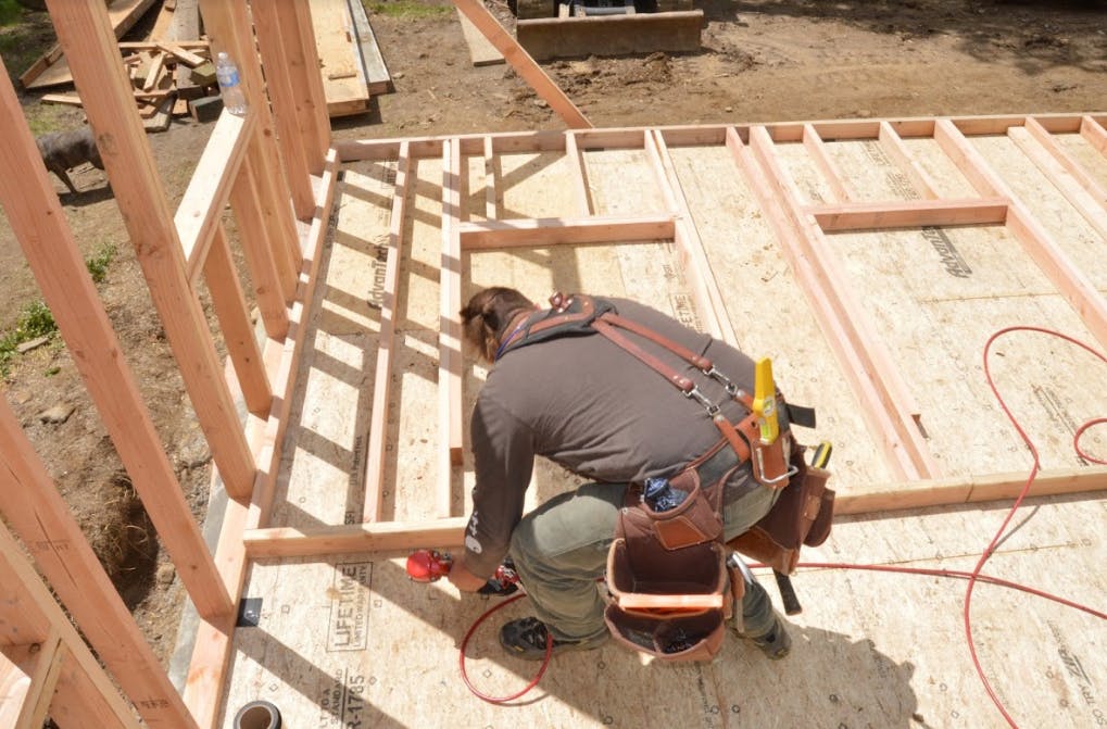 Carpenter Ben Bogie framing the walls of the model remodel project