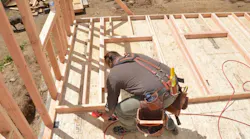 Carpenter Ben Bogie framing the walls of the model remodel project