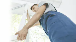 home improvement professional installing a window