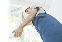 home improvement professional installing a window home improvement professional installing a window