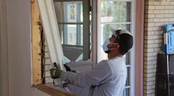 remodeler installing a window during covid-19