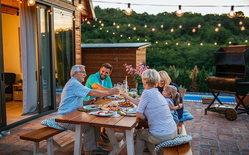 A group of people sitting at a table eating food.