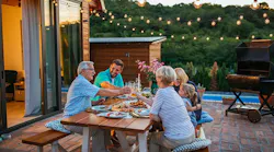 A group of people sitting at a table eating food.