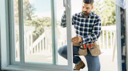 Home improvement contractor installing a sliding patio door