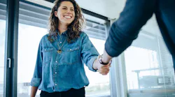 Newly hired employee shaking hands with employer