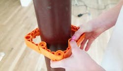 Close-up photo of the Simpliframe system being used around a pipe. Close-up photo of the Simpliframe system being used around a pipe.