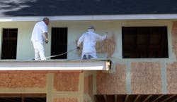 StoGuard fully adhered air and moisture barrier being applied to a wall StoGuard fully adhered air and moisture barrier being applied to a wall