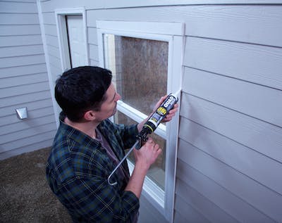Application of Quad Max caulk to an exterior window.
