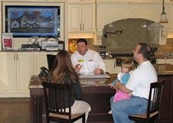 Alure Home Improvement salesman with customers in the showroom Alure Home Improvement salesman with customers in the showroom