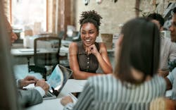 A Group Of Employees Sit Around A Conference Table And Talk During A Meeting A Group Of Employees Sit Around A Conference Table And Talk During A Meeting