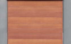 A Close Up Shot Of What Appears To Be A Warm Orange And Brown Sealed Grained Cedar Wood, Which Is In Fact Metal Siding From Mac Metal A Close Up Shot Of What Appears To Be A Warm Orange And Brown Sealed Grained Cedar Wood, Which Is In Fact Metal Siding From Mac Metal