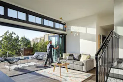 Man pushing open the Andersen Folding Outswing door Man pushing open the Andersen Folding Outswing door