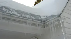 An ice dam forms on the roof of a home.