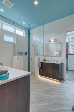 This primary suite was added to a forever home's third floor to capture the sweeping views of Puget Sound. The bathroom features an easy-access shower, his-and-her vanities with motion-sensor toe-kick lights, and wider doorways with pocket doors. Adding to the list of luxuries, there’s an indoor sauna and an adjacent deck with an outdoor kitchen and bar. This primary suite was added to a forever home's third floor to capture the sweeping views of Puget Sound. The bathroom features an easy-access shower, his-and-her vanities with motion-sensor toe-kick lights, and wider doorways with pocket doors. Adding to the list of luxuries, there’s an indoor sauna and an adjacent deck with an outdoor kitchen and bar.