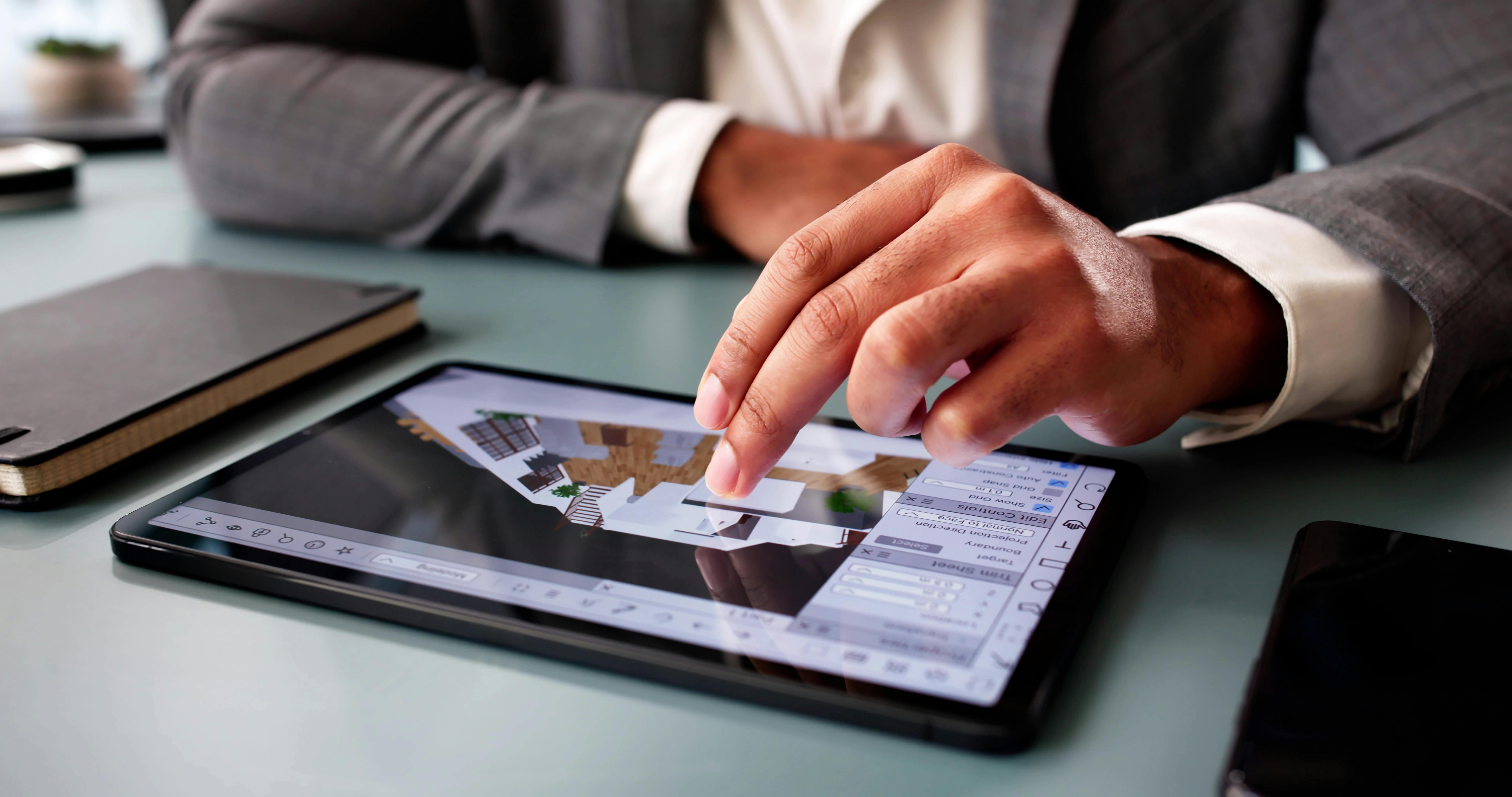 person working with design program on tablet