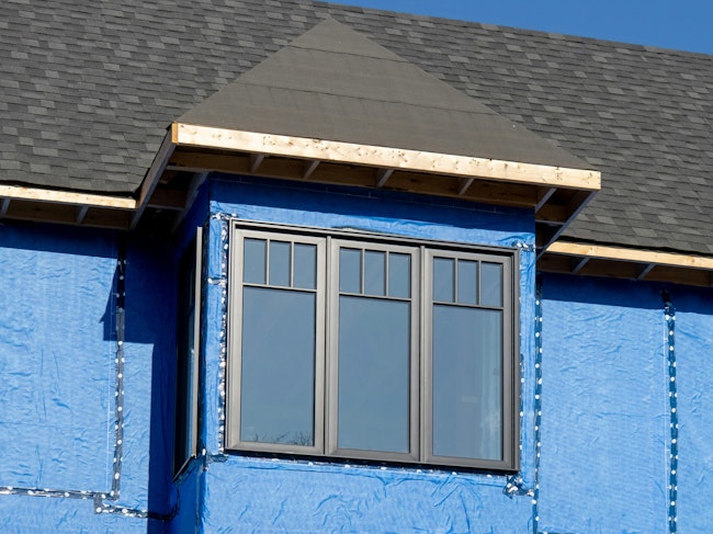 house with a layer of blue house wrap