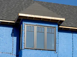 house with a layer of blue house wrap