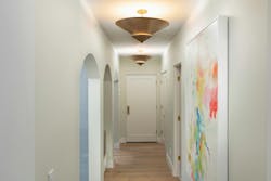 The hallway from the kitchen to the garage (above) has multiple arches, an architectural detail used throughout the house. A dog wash station (below) replaces the home’s old pantry and is used by Phil Kean’s two basset hounds, Woody and Arlo (an homage to folk music legend Woody Guthrie). The hallway from the kitchen to the garage (above) has multiple arches, an architectural detail used throughout the house. A dog wash station (below) replaces the home’s old pantry and is used by Phil Kean’s two basset hounds, Woody and Arlo (an homage to folk music legend Woody Guthrie).