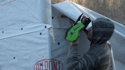 Upper sheets overlap lower sheets. It seems obvious, but it needs to be said. Water flows downhill, and if the overlaps are underlaps, the WRB becomes a WIS—a Water Injection System. This worker is securing the bottom corner and will stretch the sheet from a ladder. After this sheet is in place, the adjacent corner will be folded over and taped. Upper sheets overlap lower sheets. It seems obvious, but it needs to be said. Water flows downhill, and if the overlaps are underlaps, the WRB becomes a WIS—a Water Injection System. This worker is securing the bottom corner and will stretch the sheet from a ladder. After this sheet is in place, the adjacent corner will be folded over and taped.