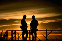 two construction workers on a jobsite two construction workers on a jobsite