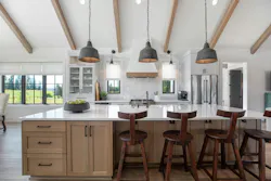 When a small 1,200-sq.ft. 1960 Cape Cod went on the market, it was quickly snapped up by homeowners who then hired Mountainwood to expand the home. The quaint country property was transformed into a modern European-style farmhouse that allows the owners to age in place. Their new kitchen has white cabinets and rift-sawn white oak cabinets on the island, a soaring ceiling, and exposed beams. When a small 1,200-sq.ft. 1960 Cape Cod went on the market, it was quickly snapped up by homeowners who then hired Mountainwood to expand the home. The quaint country property was transformed into a modern European-style farmhouse that allows the owners to age in place. Their new kitchen has white cabinets and rift-sawn white oak cabinets on the island, a soaring ceiling, and exposed beams.