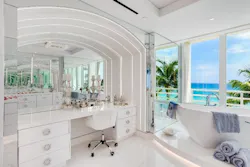 2) The dressing area utilizes layered lighting to add depth and texture to the space while also making the environment bright for the homeowner to do their makeup.