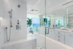 3) This view from the shower highlights the extensive use of mirrors along the walls and how they create the illusion of a larger space.