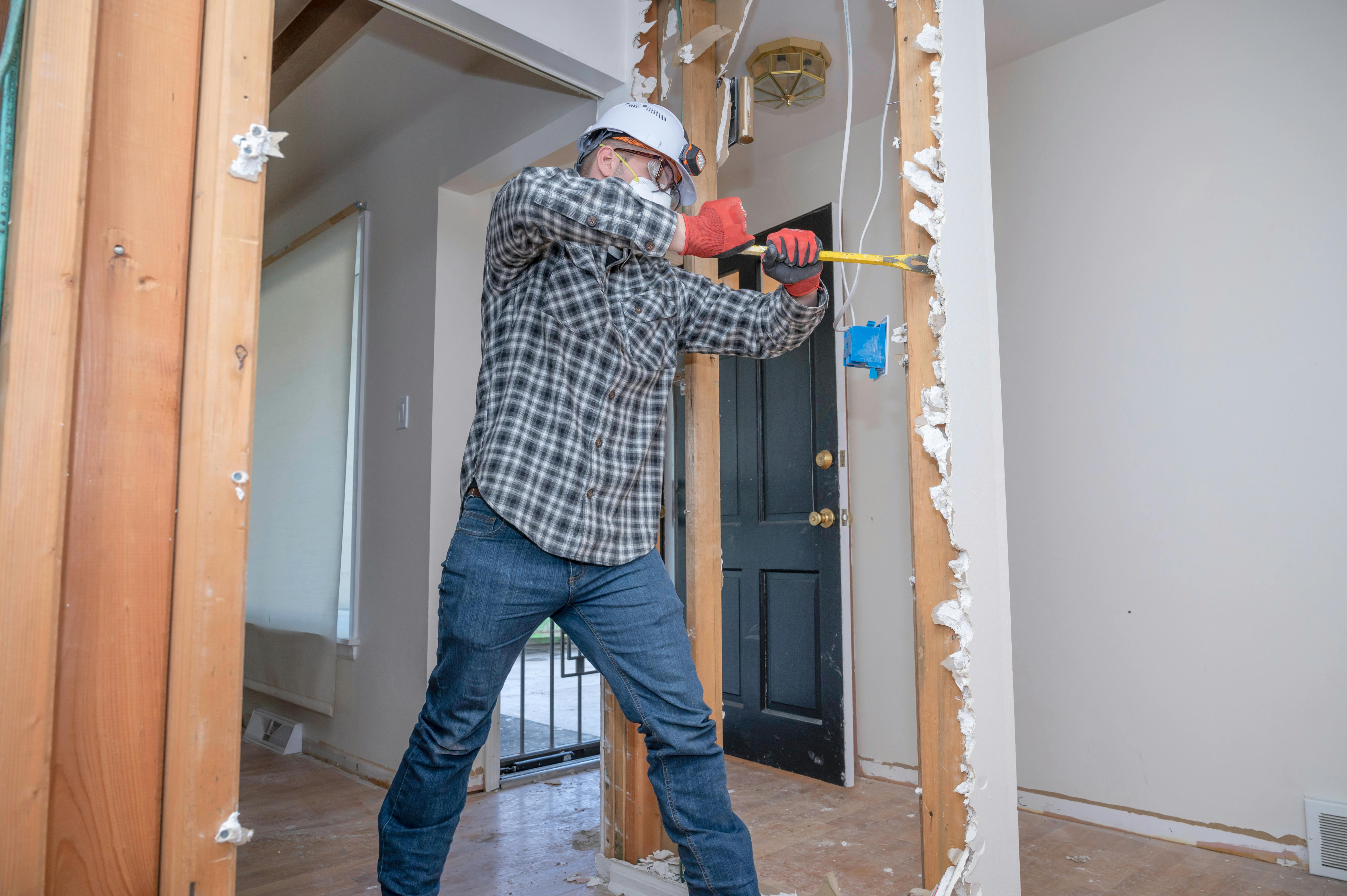 Remodeler removing drywall