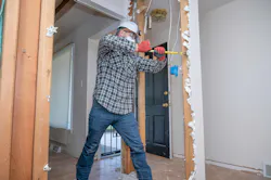 Remodeler removing drywall