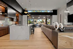 The great room above (A on the floor plan) was to feature a freestanding wine cube, but the idea was rethought once demo was finished and the room laid out. Finding that a cube wouldn’t work, a showstopping wine wall (B on the floor plan) was added to the dining area shown below. The whole house feels warm thanks to the designer’s use of darker-toned colors, different finishes, and multiple textures.