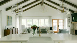 The only addition to the exiting footprint was a new living room and back porch (D and E on the floor plan). A cathedral ceiling, hand-hewn beams, and a fireplace flanked by custom cabinetry (shown above) are thoughtful details.