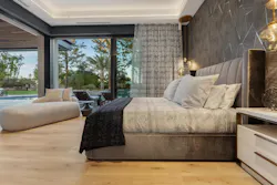 The tranquil primary suite (E on the floor plan) opens to the backyard. A really special feature of the owner's retreat is the shower with custom art panels shown below.